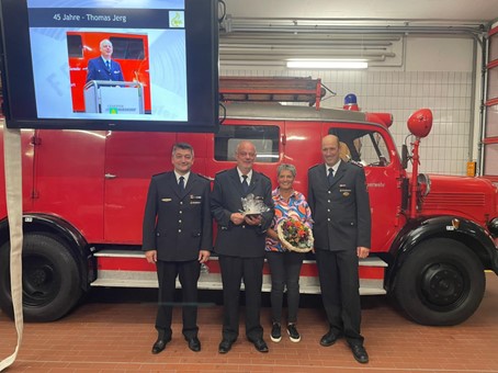 Abbildung 9: Hauptlöschmeister Thomas Jerg mit seiner Frau Carmen sowie der Feuerwehr- Führung bei der Ehrung für 45 Jahre Feuerwehrdienst